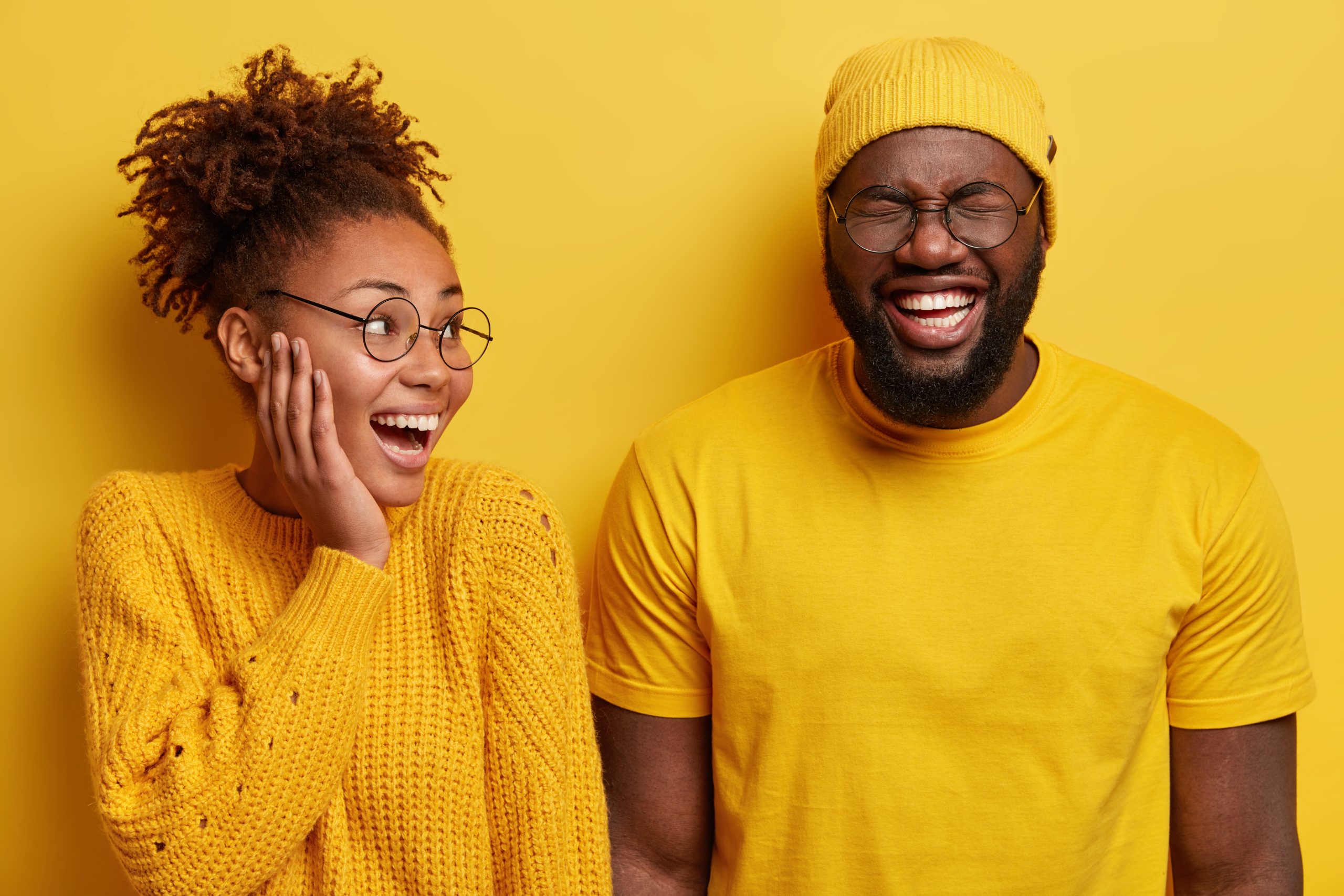 Two individuals laughing and bonding over shared quirky interests, symbolizing Freak Matching