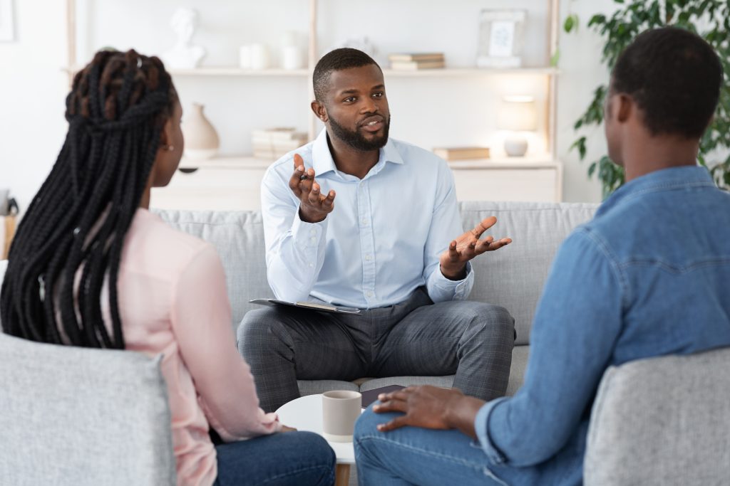 A couple in a counseling session with a therapist.