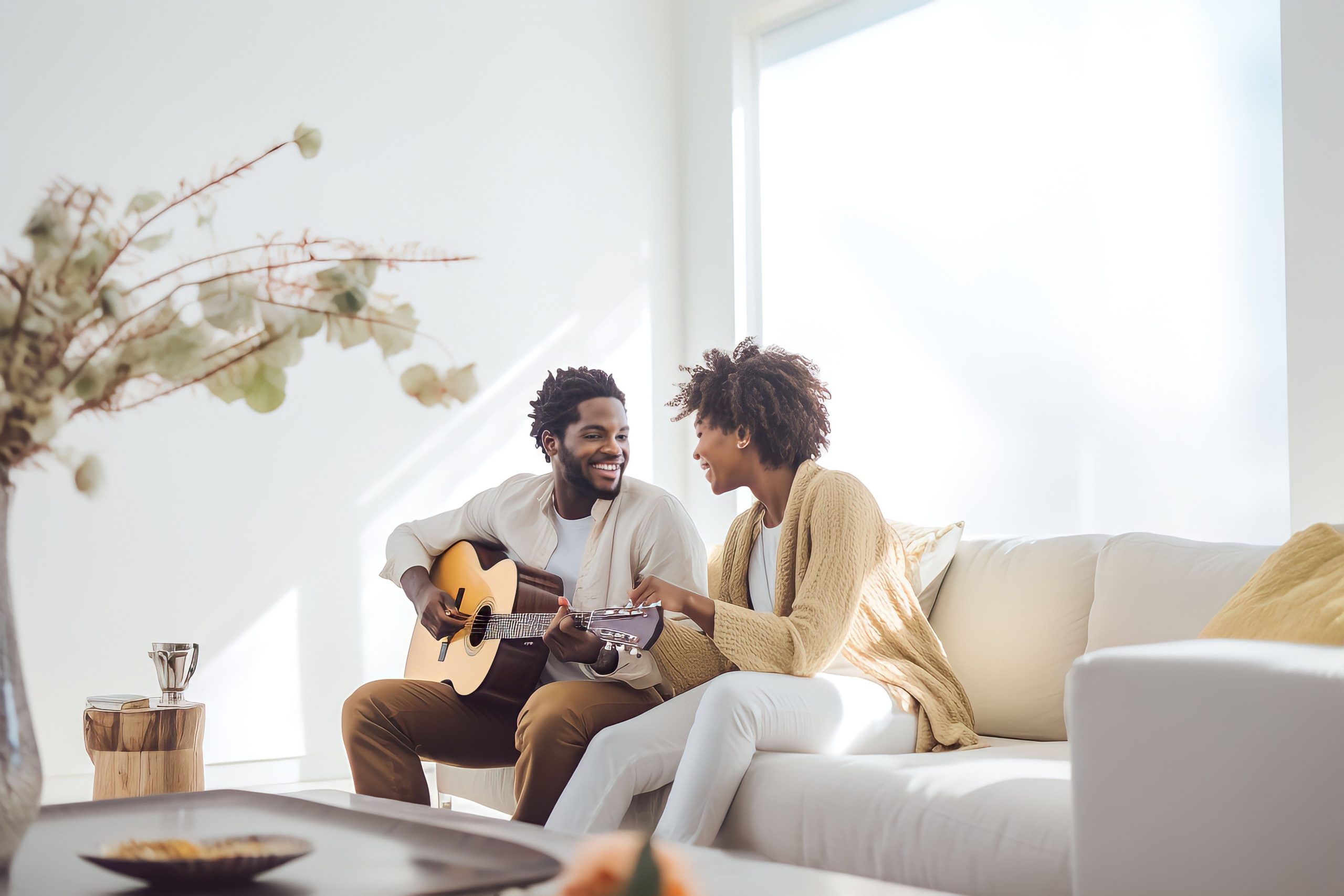 Couple sitting together, smiling and holding hands after successful marriage counseling.