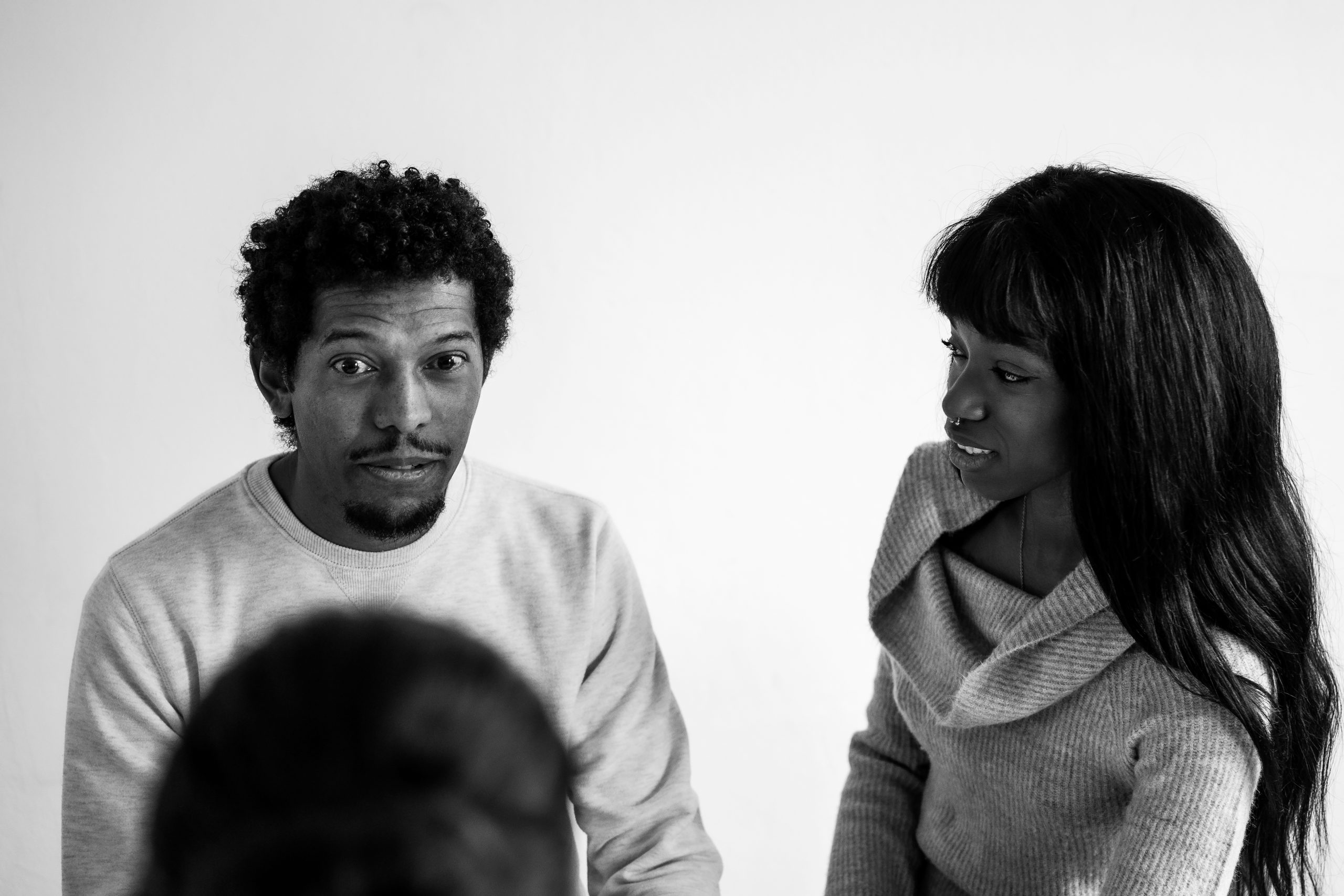 A couple having a serious conversation on the couch, symbolizing emotional honesty and conflict resolution in relationships.