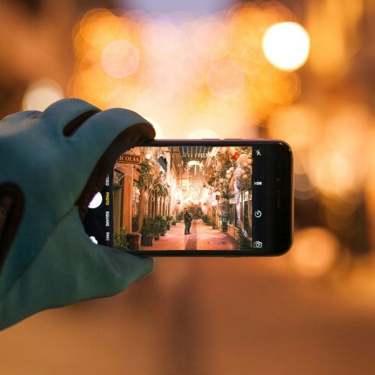 Couple taking a selfie with a smartphone, highlighting the balance between technology and relationships.